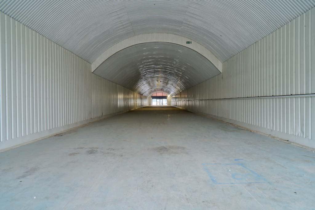 An empty arch with lining and full height glazing to the front