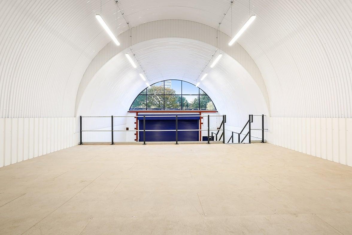 The mezzanine level of an arch with white lining.