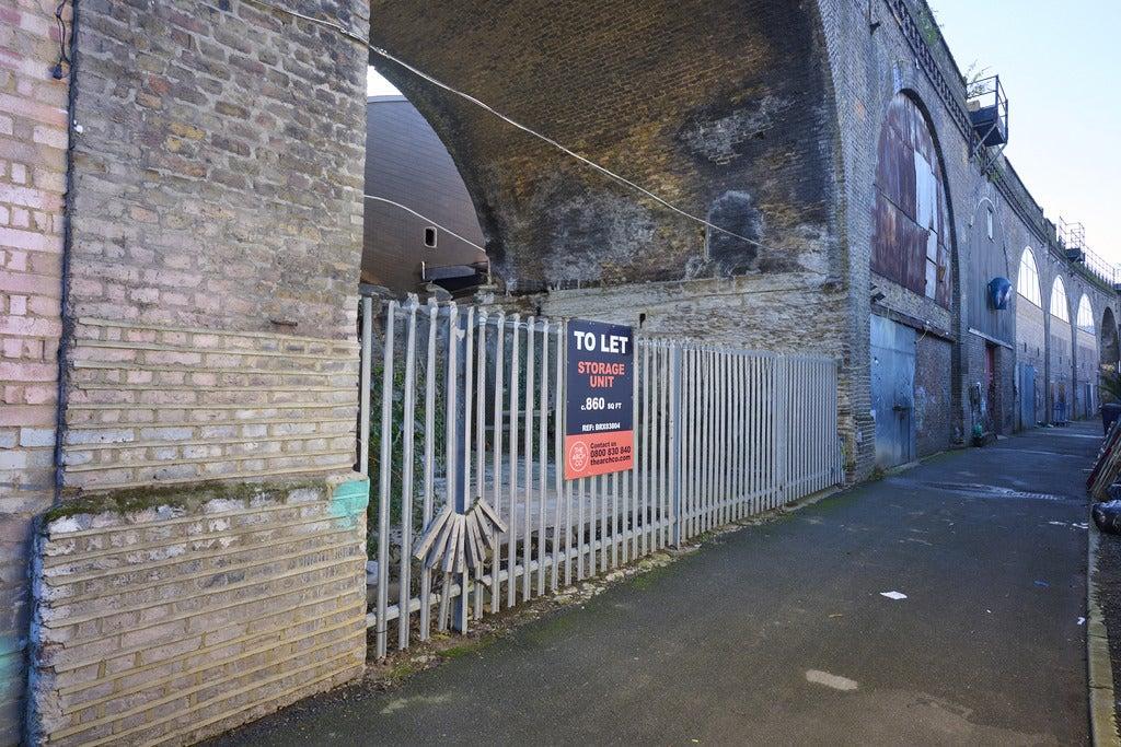 An open arch, with metal fencing around it.