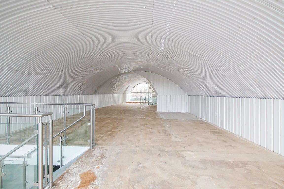 The mezzanine level of an arch with white lining.